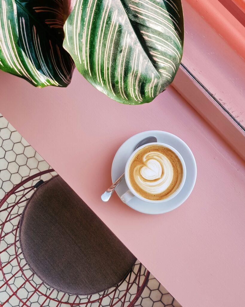 Coffee on a pink counter.