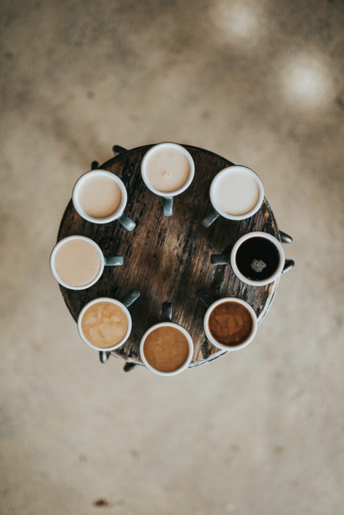 Table full of coffees in a circle.